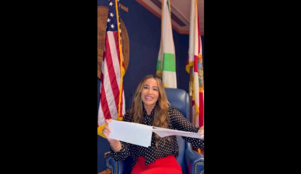 Miami-Dade Commissioner Danielle Cohen Higgins rips up a letter from an attorney representing the village of Palmetto Bay, which has questioned the legality of the commissioner’s proposal to sell a county-owned plot to a private resident.