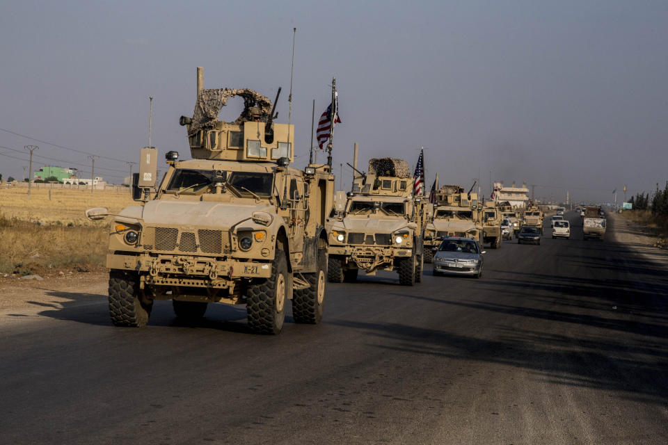 U.S. military convoy drives near the town of Qamishli, north Syria, Saturday, Oct. 26. 2019. A U.S. convoy of over a dozen vehicles was spotted driving south of the northeastern city of Qamishli, likely heading to the oil-rich Deir el-Zour area where there are oil fields, or possibly to another base nearby. The Syrian Observatory for Human Rights, a war monitor, also reported the convoy, saying it arrived earlier from Iraq. (AP Photo/Baderkhan Ahmad)