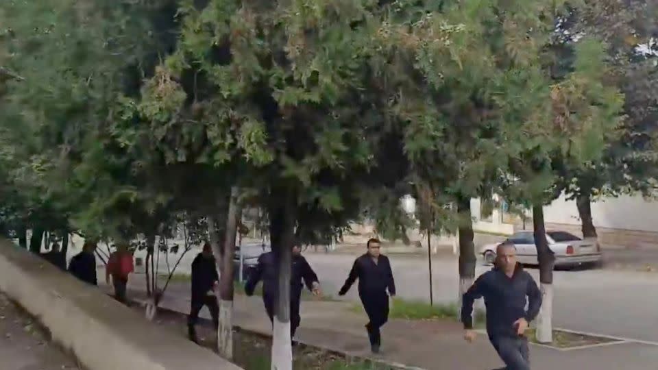 People run as gunfire and explosions are heard in Stepanakert, in the Nagorno-Karabakh region, in this screengrab obtained from a handout video. - Artsakh Public TV/Handout/Reuters