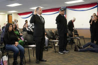 Deported veterans Mauricio Hernandez Mata, standing at left, and Leonel Contreras, standing at right, are sworn in as U.S. citizens at a special naturalization ceremony Wednesday, Feb. 8, 2023, in San Diego. Both Army veterans, the two men were among 65 who have been allowed back into the United States nearly a year ago as part of a growing effort by the U.S. government to recognize the service of immigrants who served in the U.S. military only to wind up deported. (AP Photo/Gregory Bull)