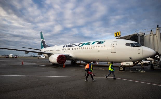 Several passengers wound up rebooking flights on another airline after WestJet cancelled their flights and rebooked them on ones that didn't work for them.  (Darryl Dyck/The Canadian Press - image credit)