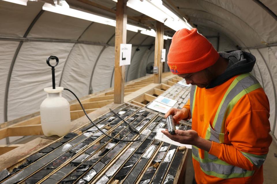 Senior project geologist for Gold Terra, Ryan Bachynski examines cut core samples.