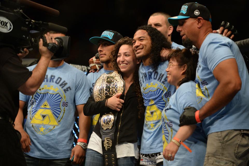 Apr 20, 2013; San Jose, CA, USA; Benson Henderson and Maria Magana pose for a photo with the rest of the team after defeating Gilbert Melendez (not pictured) during the lightweight championship bout of the UFC on Fuel TV at HP Pavilion.