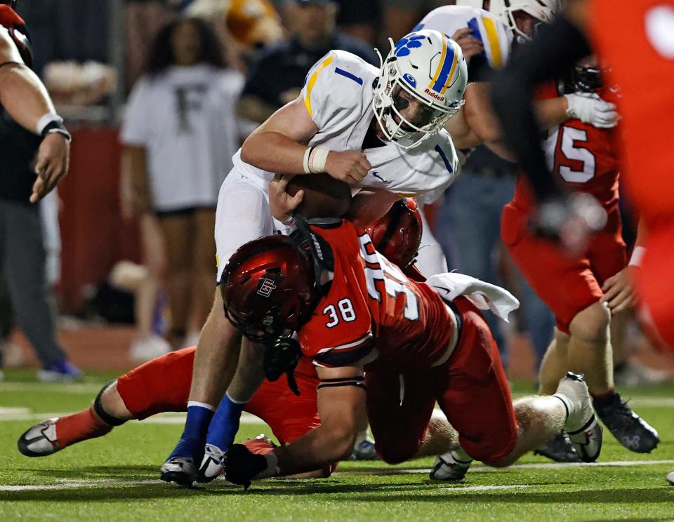 Lubbock-Cooper's Cutter Douglas (38) tackles Frenship's Hudson Hutcheson (1) during a football game, Friday, Sept. 2, 2022, at Pirate Stadium at First United Park. 