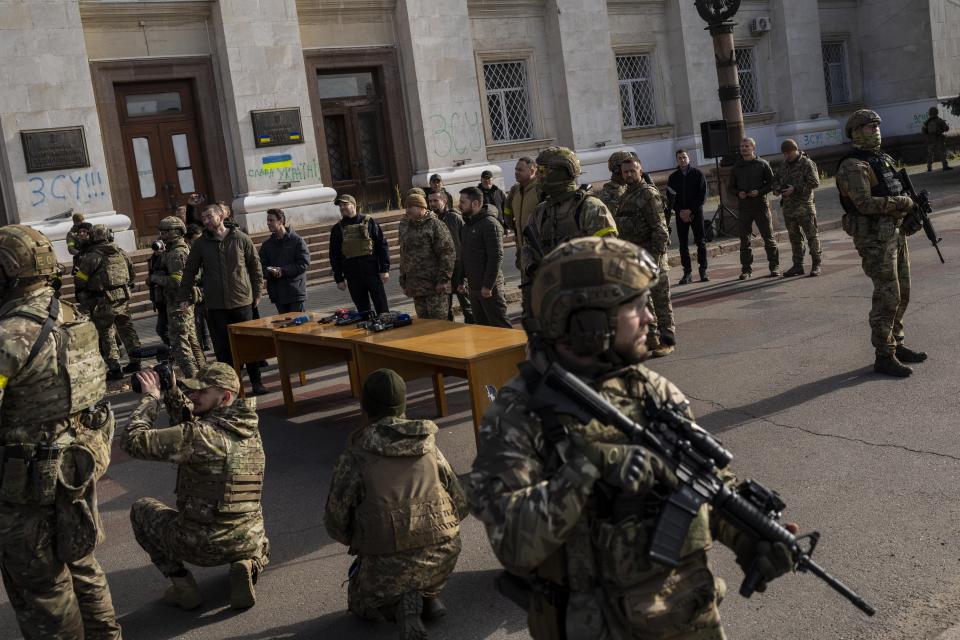 Ukrainian President Volodymyr Zelensky guarded by soldiers, gives a speech in Kherson, southern Ukraine, Monday, Nov. 14, 2022. Ukraine's retaking of Kherson was a significant setback for the Kremlin and it came some six weeks after Russian President Vladimir Putin annexed the Kherson region and three other provinces in southern and eastern Ukraine — in breach of international law — and declared them Russian territory. (AP Photo/Bernat Armangue)