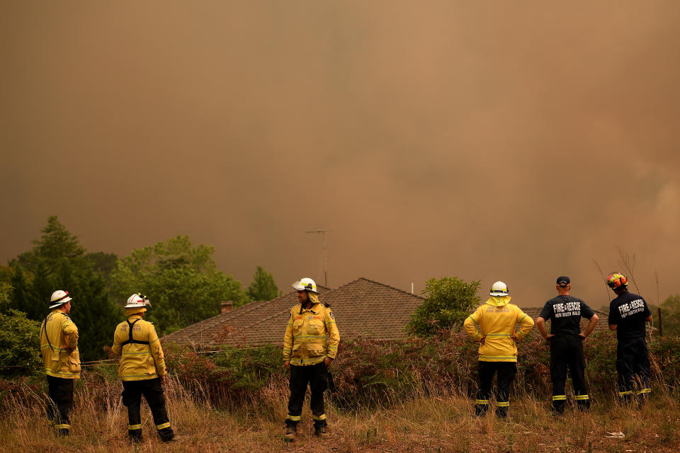 NSW Rural Fire Service and Fire and Rescue NSW firefighters watch on as the Grose Valley Fire approaches on Saturday, December 21, 2019. Source: AAP Image/Dan Himbrechts