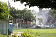 <p>Emergency personnel put water on the scene of school building collapse at Minnehaha Academy in Minneapolis, Minnesota, August 2, 2017. (Adam Bettcher/Reuters) </p>