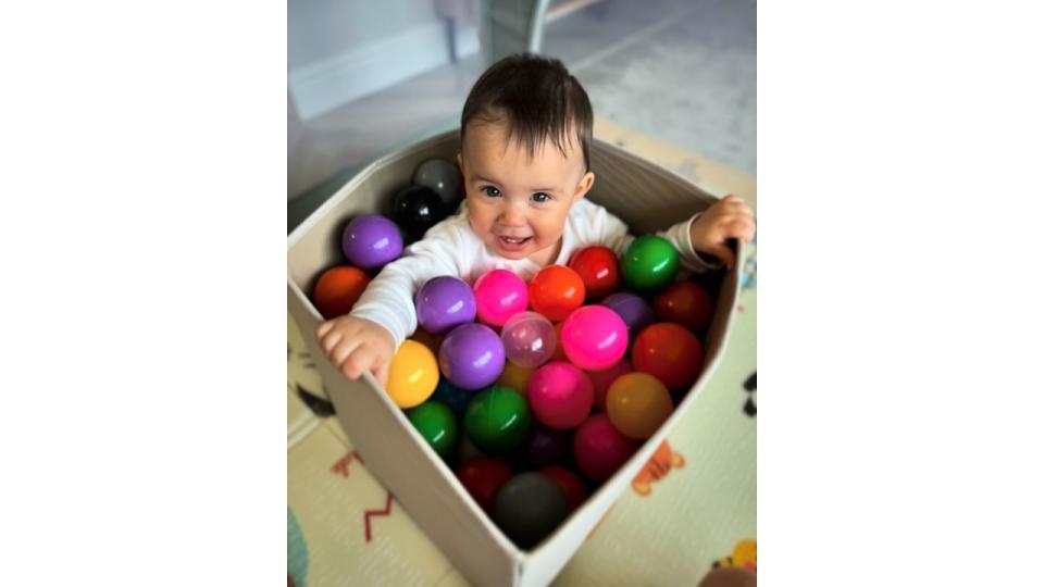 baby girl playing in small ball pit
