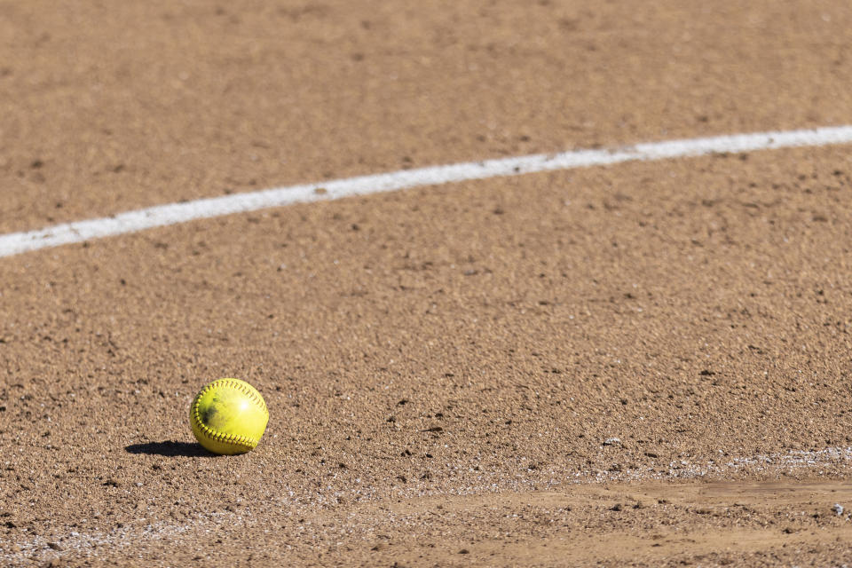 A generic image of a softball in the dirt during an NCAA softball game on Saturday Feb. 19, 2022, in Raleigh, N.C. (AP Photo/Kara Durrette)