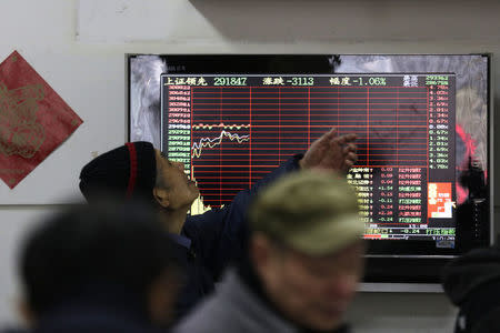 An investor looks at a screen showing stock information at a brokerage house in Shanghai, China, January 14, 2016. REUTERS/Aly Song