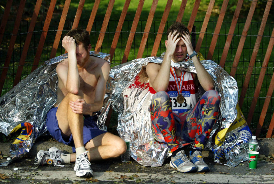 <p>Exhausted runners rest at the end of the New York City Marathon in Central Park November 2, 2003 in New York City. Over 30,000 runners from all over the world participated in the annual race, one of most famous marathons in the world. (Photo by Chris Hondros/Getty Images) </p>