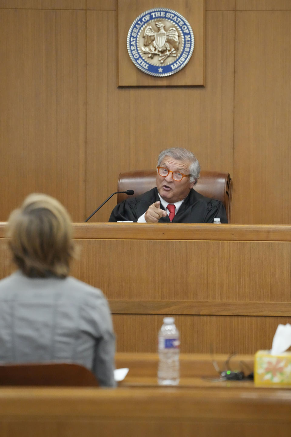 Hinds County Chancery Judge Dewayne Thomas, right, cautions Karissa Bowley, wife of the late Dau Mabil, a 33-year-old Jackson, Miss., resident who went missing on March 25 and whose body was found in April floating in the Pearl River in Lawrence County, to not interrupt attorneys' questioning during a hearing, Tuesday, April 30, 2024 in Jackson, Miss. The hearing is on whether a judge should dissolve or modify his injunction preventing the release of Mabil's remains until an independent autopsy could be conducted. (AP Photo/Rogelio V. Solis)