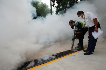 A worker fogs the drains in the common areas of a public housing estate at an area where locally transmitted Zika cases were discovered in Singapore August 31, 2016. REUTERS/Edgar Su