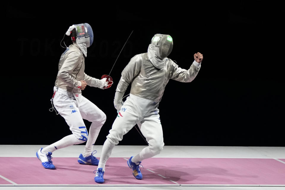 Aron Szilagyi of Hungary, right, celebrates winning the gold medal after defeating Luigi Samele of Italy compete in the men's individual final Sabre competition at the 2020 Summer Olympics, Saturday, July 24, 2021, in Chiba, Japan. (AP Photo/Hassan Ammar)