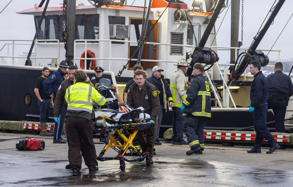 This image provided by NBC10 Boston shows first responders tending to a man on a stretcher Tuesday, Sept. 26, 2023, in Boston, who had fallen overboard from the tanker MTM Dublin in rough seas off Boston. Officials say the crew of a fishing boat recovered a man who had fallen overboard from a tanker and began CPR. The Coast Guard says a mayday from the tanker MTM Dublin went out shortly after 4:30 a.m. The man’s condition is not known. (NBC10 via AP)