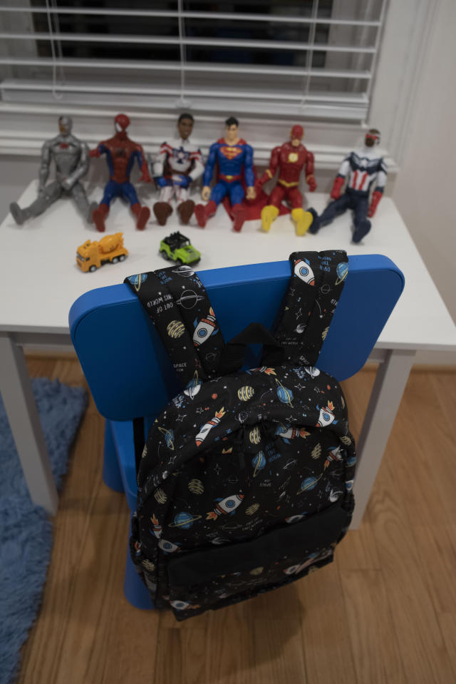 Super Hero toys and a backpack sit in the bedroom set up for Peterson, a five-year-old Haitian boy who has been adopted by Bryan and Julie Hanlon, to use when he arrives to their home in Washington D.C., Tuesday, Feb. 7, 2023. The Hanlons became the legal parents of Peterson and his six-year-old sister Gina in 2022 but fear they won't be able to secure their passports and fly them out of Haiti. (AP Photo/Cliff Owen)