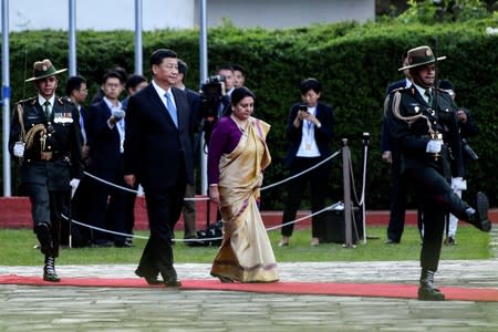 Nepal's President Bidhya Devi Bhandari and China's President Xi Jinping inspect an honor guard during a welcome ceremony at the Tribhuvan International Airport in Kathmandu