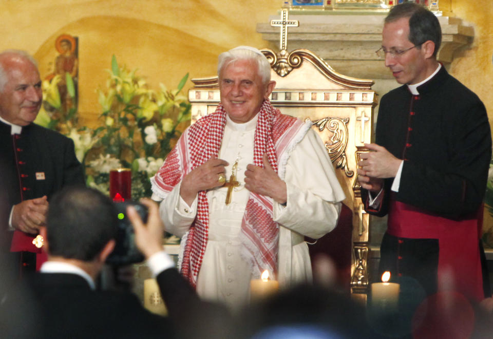 FILE - Pope Benedict XVI wears a traditional Jordanian "Keffeyeh" that was presented to him during his visit to the Lady of Peace Church in Amman, Jordan, on May 8, 2009. Pope Emeritus Benedict XVI, the German theologian who will be remembered as the first pope in 600 years to resign, has died, the Vatican announced Saturday. He was 95. (AP Photo/Nasser Nasser, File)