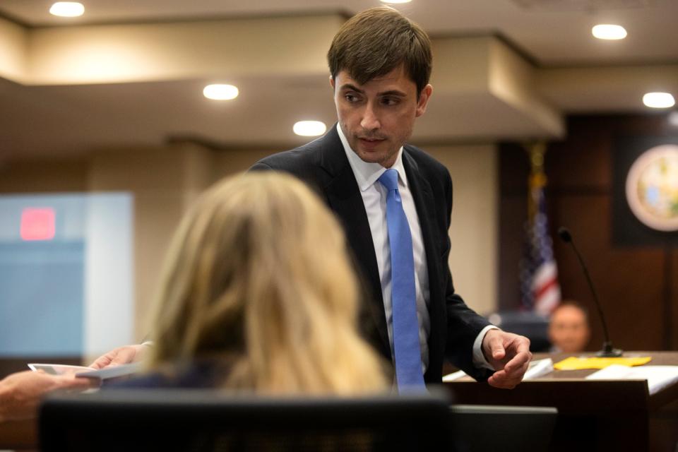 Defense attorney Christopher DeCoste passes evidence to Assistant State Attorney Georgia Cappleman during the trial of Katherine Magbanua on Wednesday, May 18, 2022.