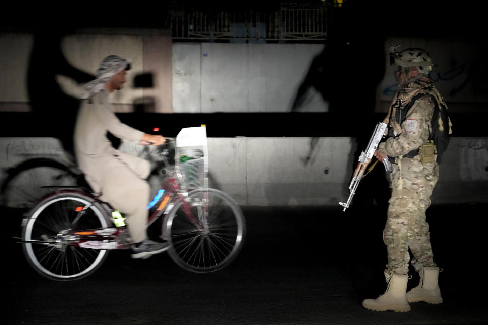 A Taliban fighter stands guard at the site of an explosion in front of the Kabul International Cricket Stadium, in Kabul, Afghanistan, Friday, July 29, 2022. (AP Photo/Ebrahim Noroozi)