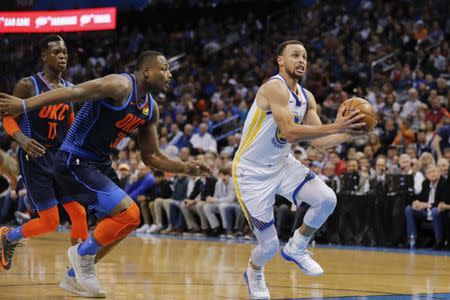 Mar 16, 2019; Oklahoma City, OK, USA; Golden State Warriors guard Stephen Curry (30) drives to the basket ahead of Oklahoma City Thunder guard Deonte Burton (30) during the first half at Chesapeake Energy Arena. Mandatory Credit: Alonzo Adams-USA TODAY Sports