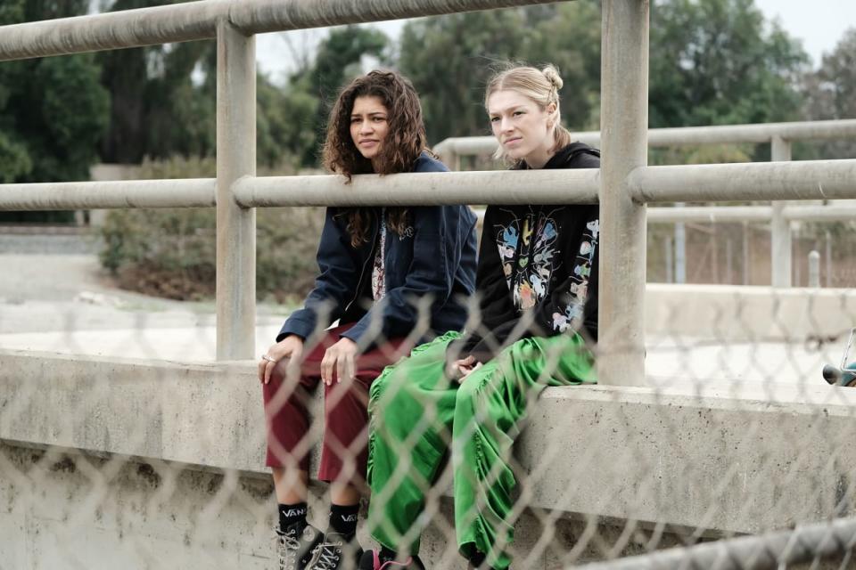 Hunter Schafer and Zendaya sit in a still from 'Euphoria'