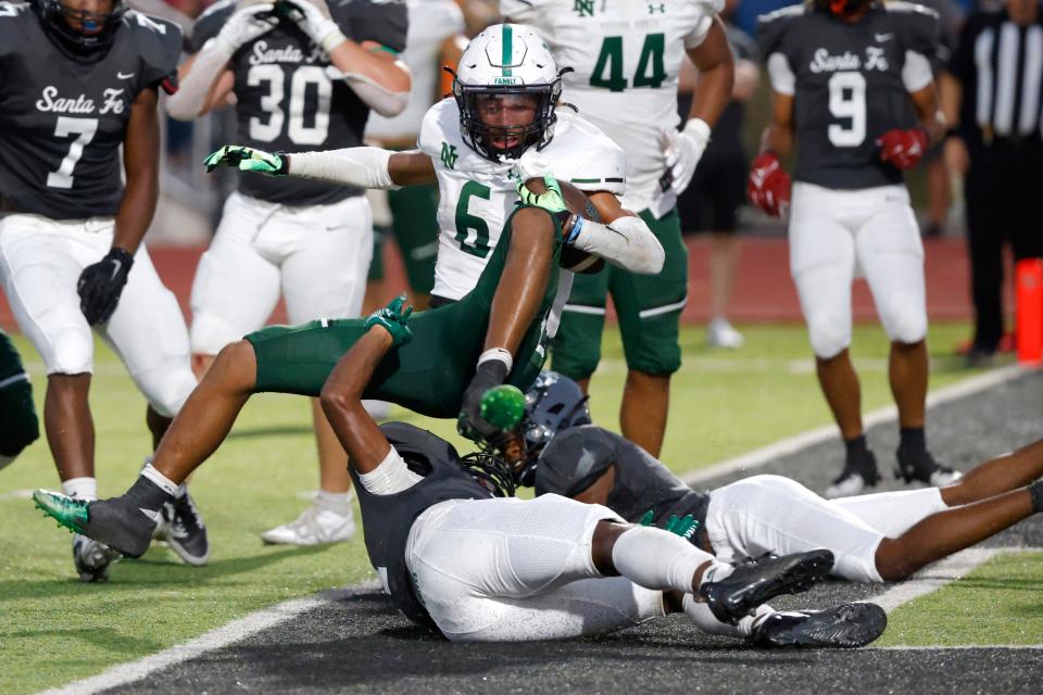 Norman North's Mason James scores a 2-point conversion during a 31-28 win at Edmond Santa Fe on Friday night.