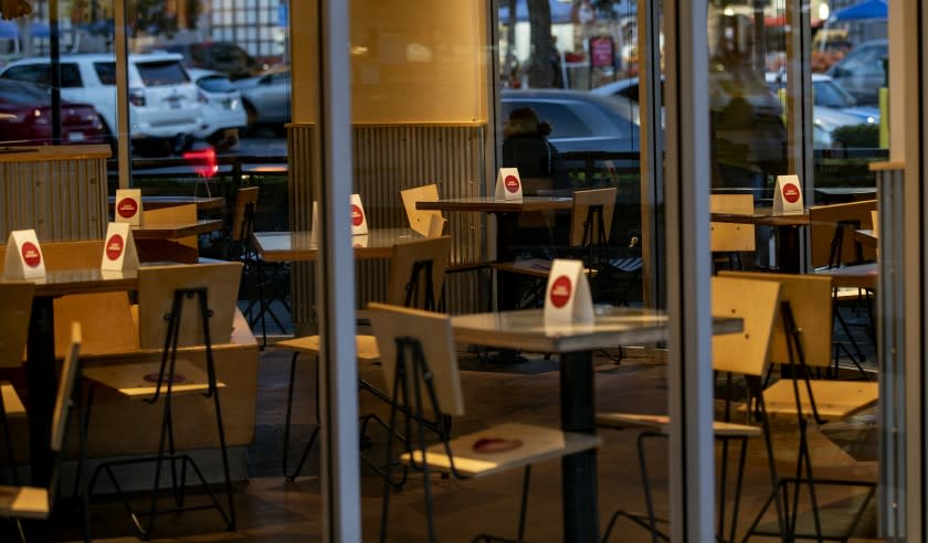 RIVERSIDE, CA - OCTOBER 21, 2020: Table top signs restrict patrons from sitting inside Indoor Chipotle restaurant as rising coronavirus rates forced Riverside County back into the most restrictive tier of the state's coronavirus reopening framework on October 21, 2020 at the Riverside Plaza in Riverside, California. The new health ruling means that restaurants, gyms, movies theaters and places of worship can no longer have limited indoor operations.(Gina Ferazzi / Los Angeles Times)