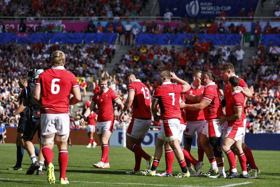 Welsh players celebrate after teammate Tomas Francis scored a try during the Rugby World Cup Pool C match between Wales and Georgia at the Stade de la Beaujoire in Nantes, western France, Saturday, Oct. 7, 2023. (AP Photo/Jeremias Gonzalez)