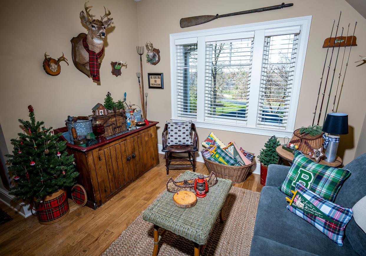 Julie Hunt's decorated room with pillows she made and a tree with fish bobbers and lures on Saturday November 11, 2023 in Hartland, Wis. Julie Hunt makes decorative pillows out of a wide variety of fabrics, including varsity letters, and her pieces will be featured on this year's Monches Artisans Holiday Open House Tour.