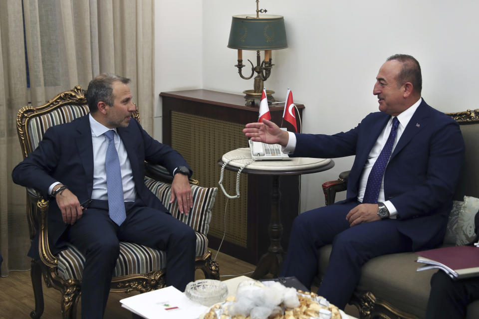 Lebanese Foreign Minister Gibran Bassil, left, meets with his Turkish counterpart Mevlut Cavusoglu, at the Lebanese foreign ministry, in Beirut, Lebanon, Friday, Aug. 23, 2019. (AP Photo/Bilal Hussein)