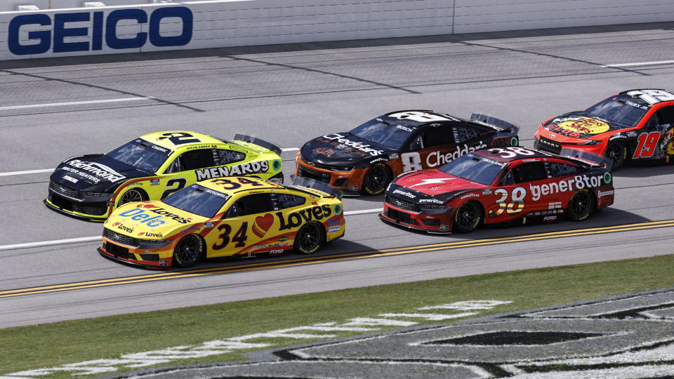 NASCAR driver's Michael McDowell (34), Austin Cindric (2) and Todd Gilliland (38) during a NASCAR Cup Series auto race at Talladega Superspeedway, Sunday, April 21, 2024, in Talladega. Ala. (AP Photo/Butch Dill)