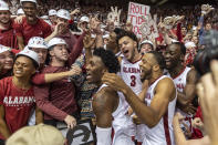 Alabama forward Alex Reese (3) and teammates join the Alabama student section to celebrate after an NCAA college basketball game against Auburn, Wednesday, Jan. 15, 2020, in Tuscaloosa, Ala. (AP Photo/Vasha Hunt)