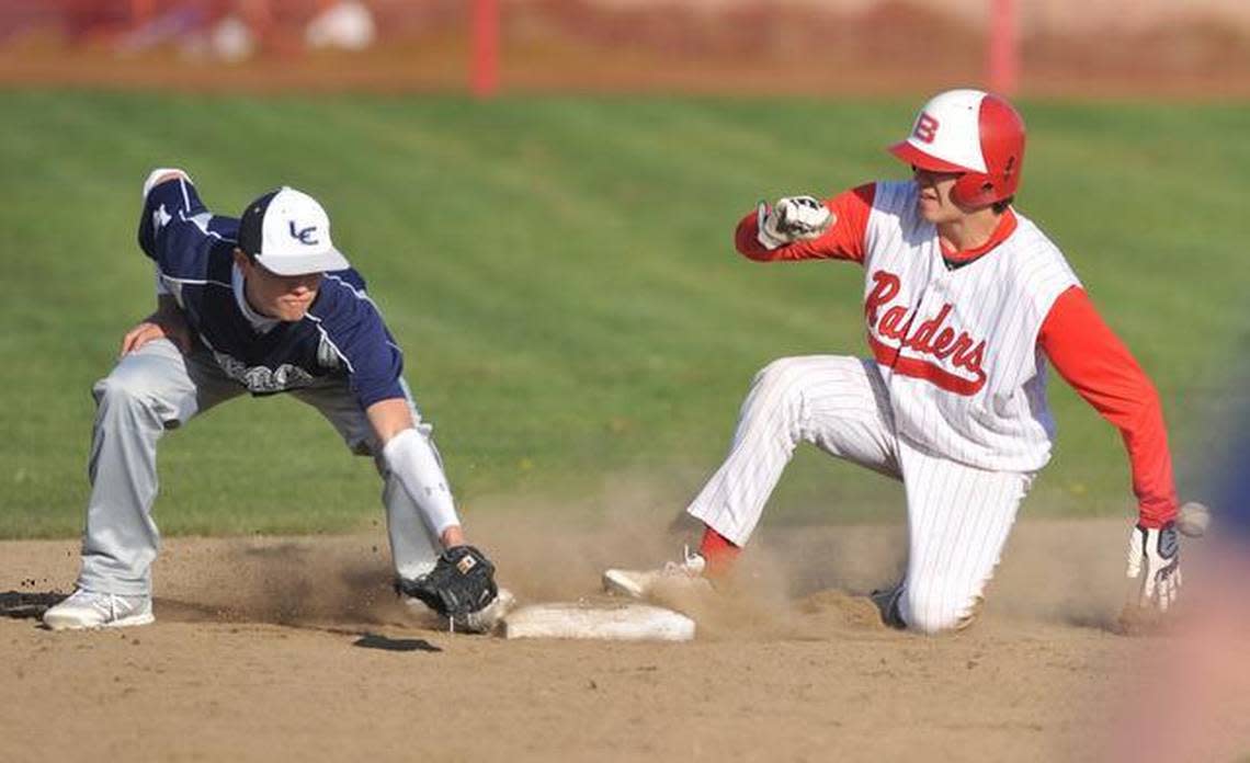 Bellingham’s Austin Shenton, right, slides to second as Lynden Christian’s Truman Van Dalen misses a catch Monday, April 1, 2013, in Bellingham.