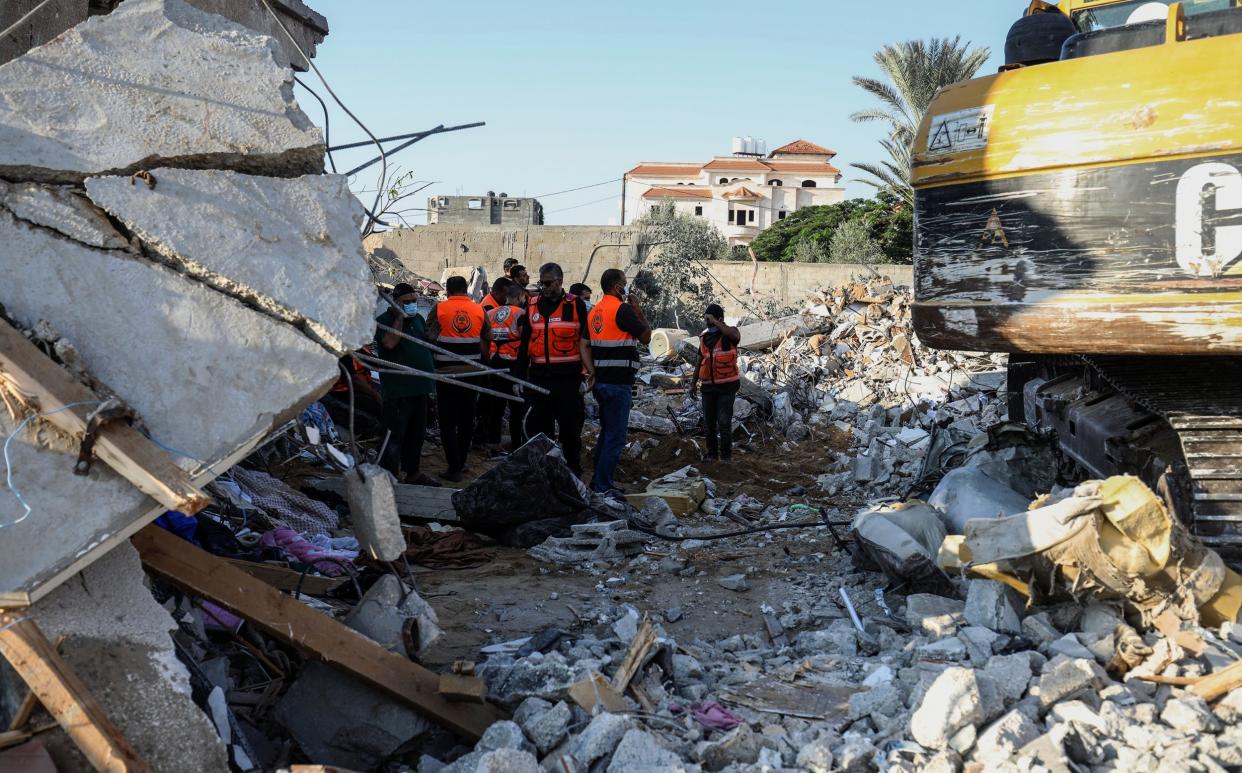 Civil defense teams and residents launch a search and rescue operation around the rubbles of destroyed buildings as Israeli attacks continue on the 10th day in Rafah, Gaza on October 16, 2023.
