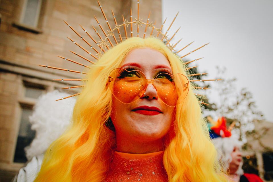 A True/False Q Queen watches the March March parade move down Ninth Street at True/False 2022.