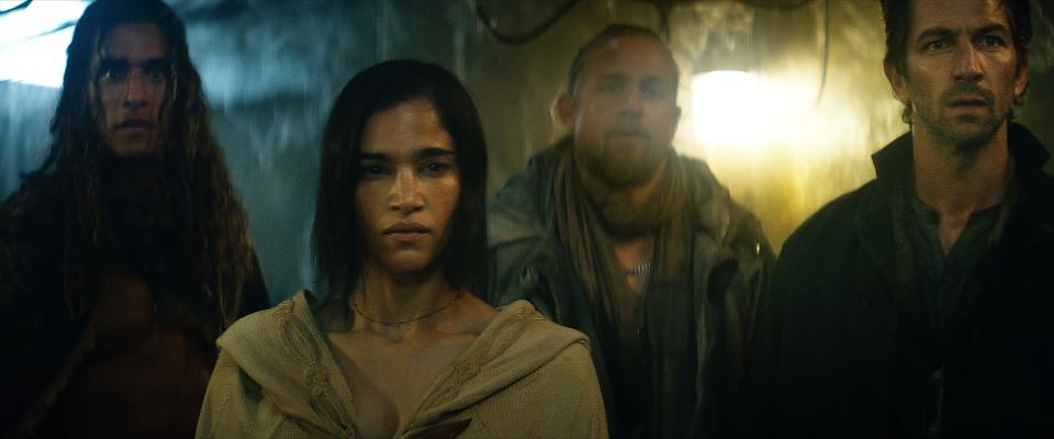 Sofia Boutella gets ready for a cape moment as Kora in "Rebel Moon." Her assembled team includes (from left) Staz Nair as Tarak, Charlie Hunnam as Kai and Michiel Huisman as Gunnar.