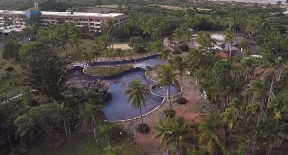 An aerial view of the Capricorn Resort's crumbling swimming pool and neglected landscaping.