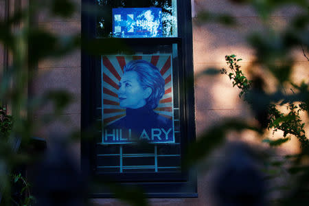 Hillary Clinton signs are hung on a window in the Carroll Gardens neighborhood of Brooklyn, New York, U.S., September 23, 2016. Picture taken September 23, 2016. REUTERS/Brendan McDermid