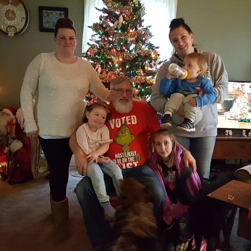 Megan Scott Glover (Right holding baby) poses with her sister Jessica (left), their children and their father Tony Scott (center) in his Christmas 2018 photo.