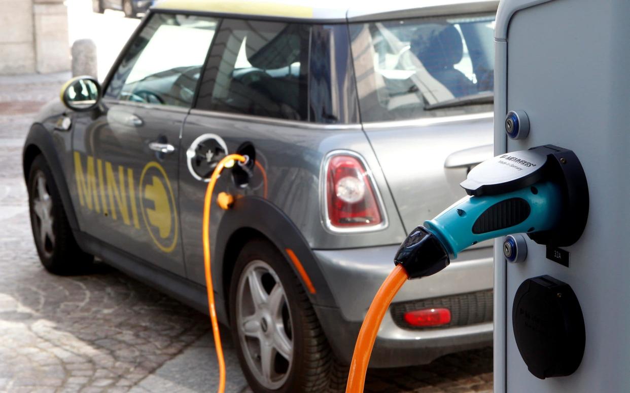 A BMW Mini electric car is charged at a station - REUTERS