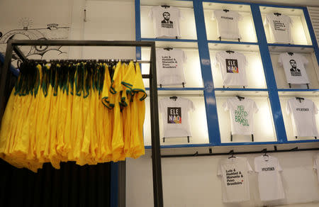 T-shirts with messages about Presidential candidates Jair Bolsonaro and Fernando Haddad are displayed at a cloth stamping store in Rio de Janeiro, Brazil October 17, 2018. REUTERS/Ricardo Moraes