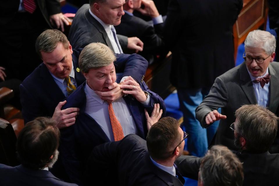 Rep. Richard Hudson, R-N.C., left, pulls Rep. Mike Rogers, R-Ala., back as they talk with Rep. Matt Gaetz, R-Fla., and others during the 14th round of voting for speaker as the House meets for the fourth day to try and elect a speaker and convene the 118th Congress in Washington, Friday, Jan. 6, 2023. At right is Rep. Patrick McHenry, R-N.C. (AP Photo/Andrew Harnik)