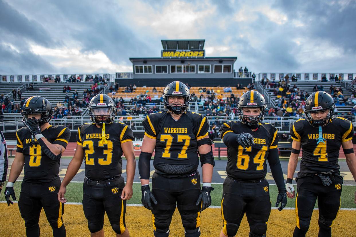 Watkins Memorial junior captains Jimmy Bogle (77) and John Apel (4) take to Ascena Field with senior captains Victor Oliver (23), Sean Sheehan (8) and Colton Rhoades (64) prior to the senior night game with Granville on Oct. 20, 2023.