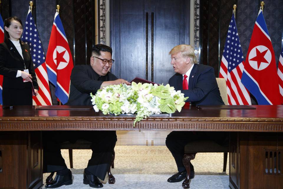 President Donald Trump and North Korean leader Kim Jong Un participate in a signing ceremony during a meeting on Sentosa Island, Tuesday, June 12, 2018, in Singapore. (AP Photo/Evan Vucci)