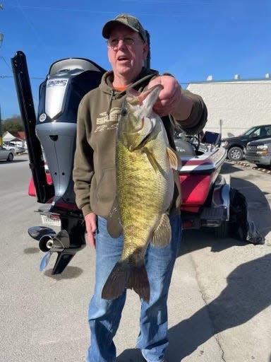 Rex Remington with his record-setting smallmouth bass which he pulled from Lake Monroe.