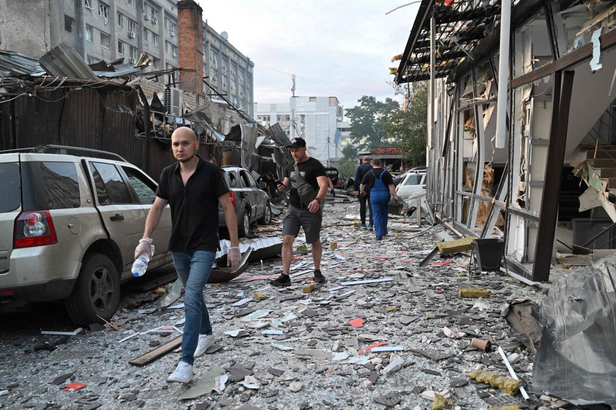 People walk past a restaurant in Kramatorsk, eastern Ukraine, after a missile strike hit (AFP via Getty Images)