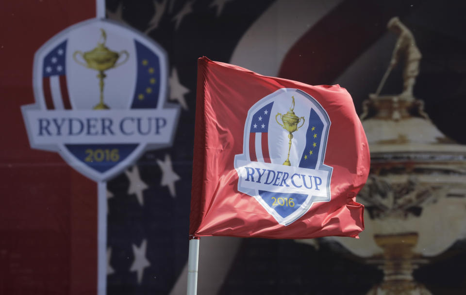 FILE - This Sept. 26, 2016, file photo shows a flag blowing in the wind before the Ryder Cup golf tournament at Hazeltine National Golf Club in Chaska, Minn. The Ryder Cup was postponed until 2021 in Wisconsin because of the COVID-19 pandemic that raised too much uncertainty whether the loudest event in golf could be played before spectators. The announcement Wednesday, July 8, 2020, was inevitable and had been in the works for weeks as the PGA of America, the European Tour and the PGA Tour tried to adjust with so many moving parts.(AP Photo/Charlie Riedel, File)
