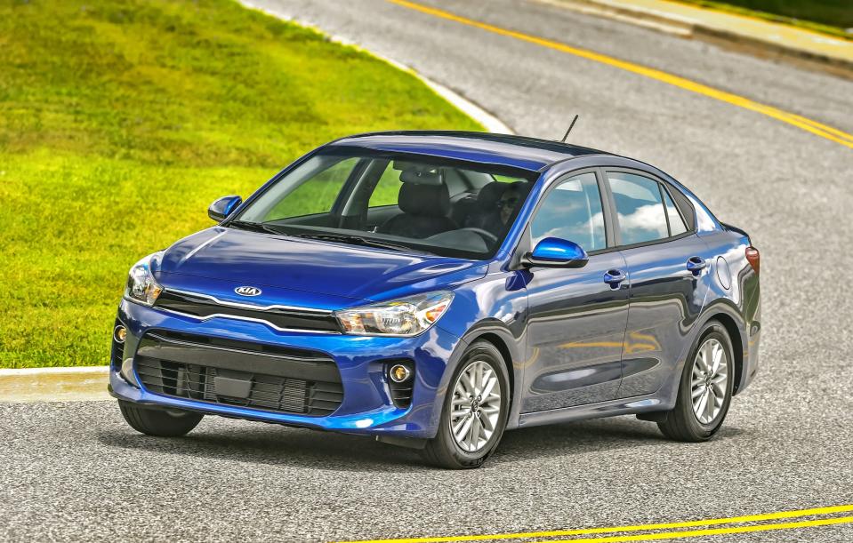 A blue 2020 Kia Rio subcompact sedan on a road.