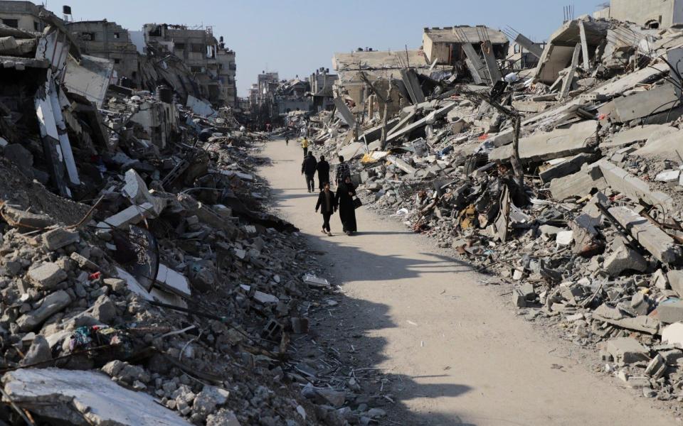 Palestinians survey scenes of destruction in the Jabaliya refugee camp